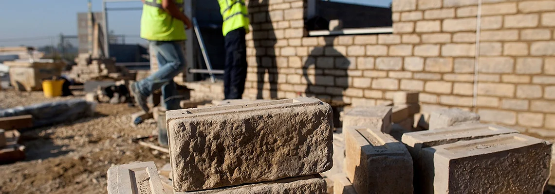 A group of bricklayers at work.