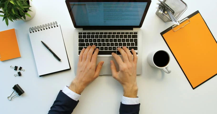 A person working on a MacBook laptop.