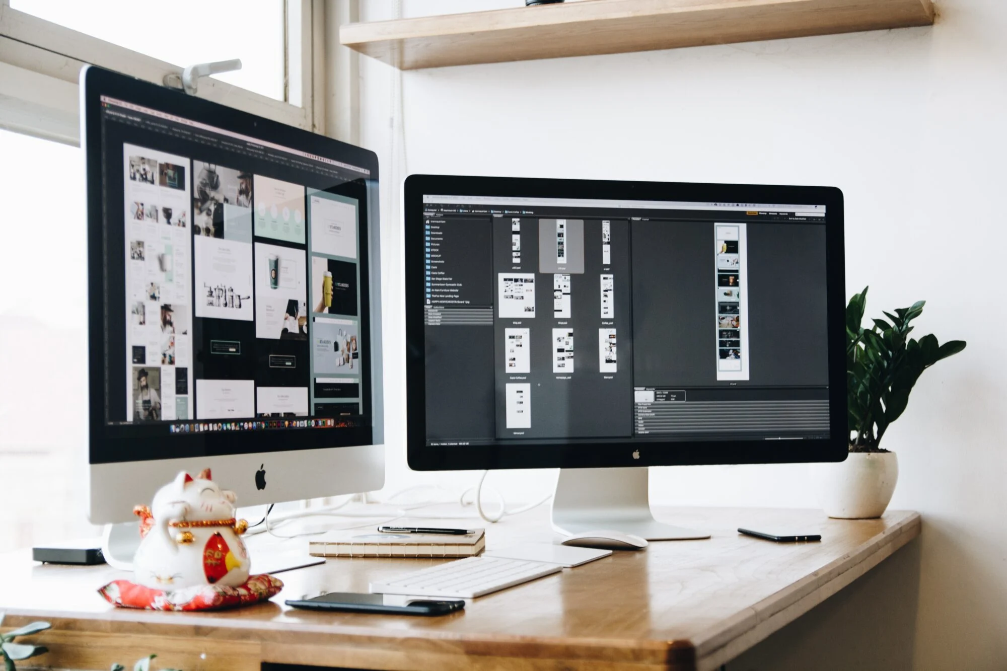 Two silver and black iMacs with a range of designs featured on Photoshop. 
