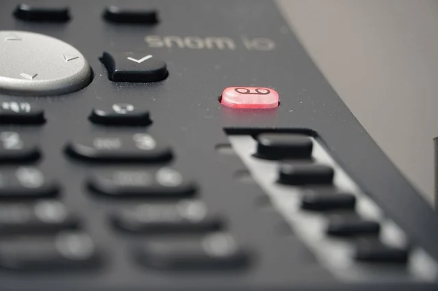 A phone with the voicemail button glowing red. 