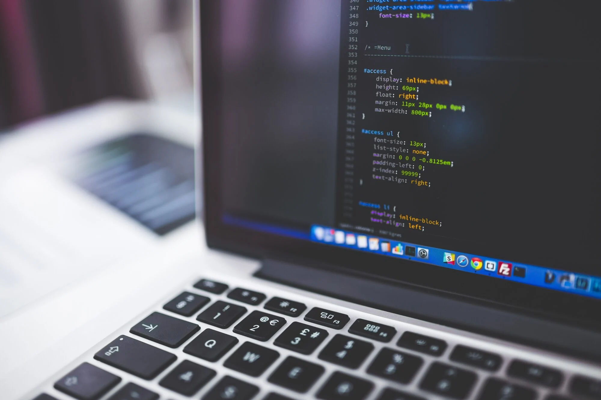 Close-up of CSS website code on a laptop screen