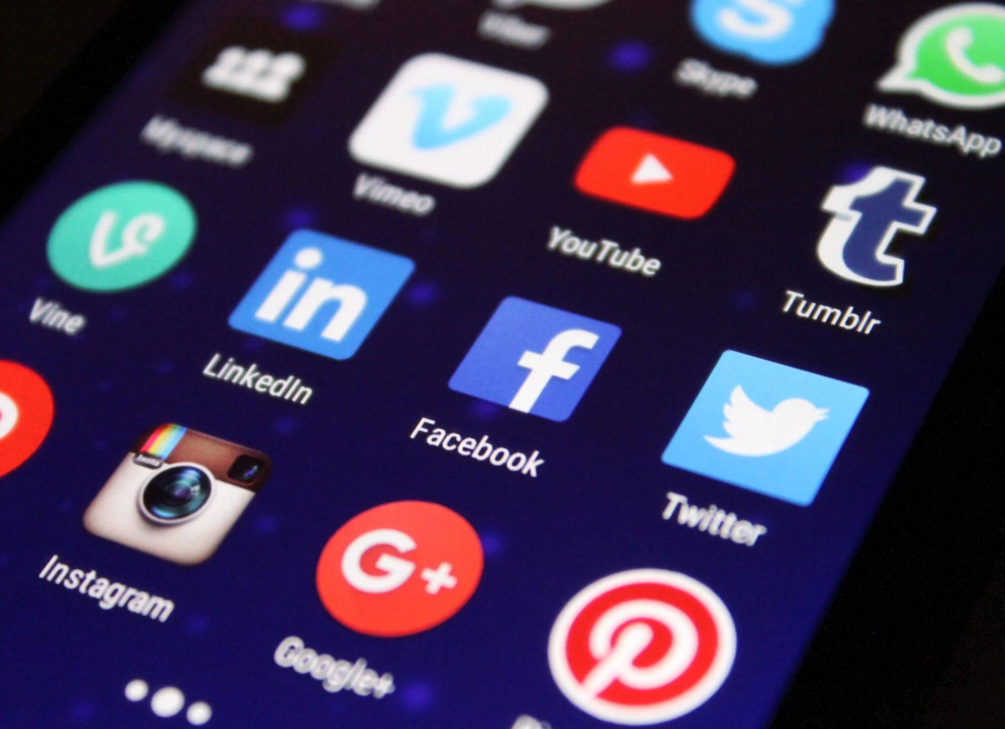 Smartphone screen filled with social media app icons including Facebook, LinkedIn and YouTube