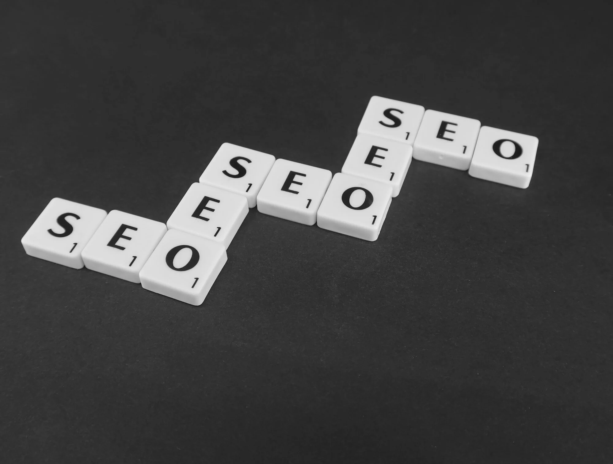 A selection of scrabble letters spelling the word SEO whilst getting higher. 