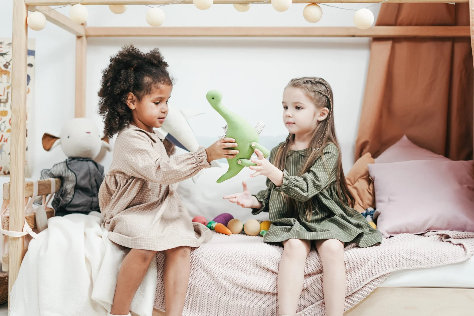 Two children reciprocating by sharing a toy.