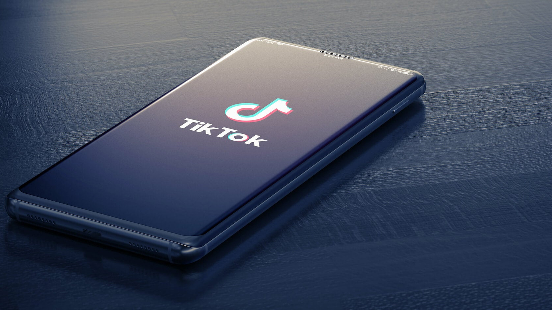 An iPhone with the Tick Tok app launching with the Tik Tok logo displayed as the loading screen.