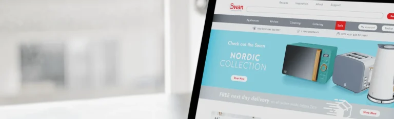 An Apple computer with a screenshot of the Swan website homepage.