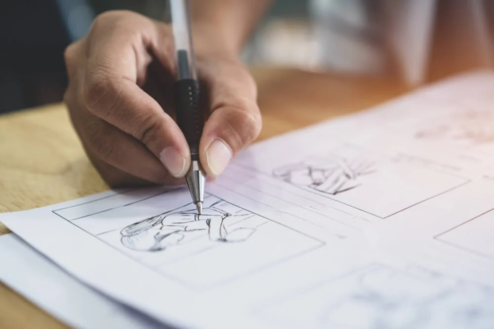 Photograph of man storyboarding video concept by hand