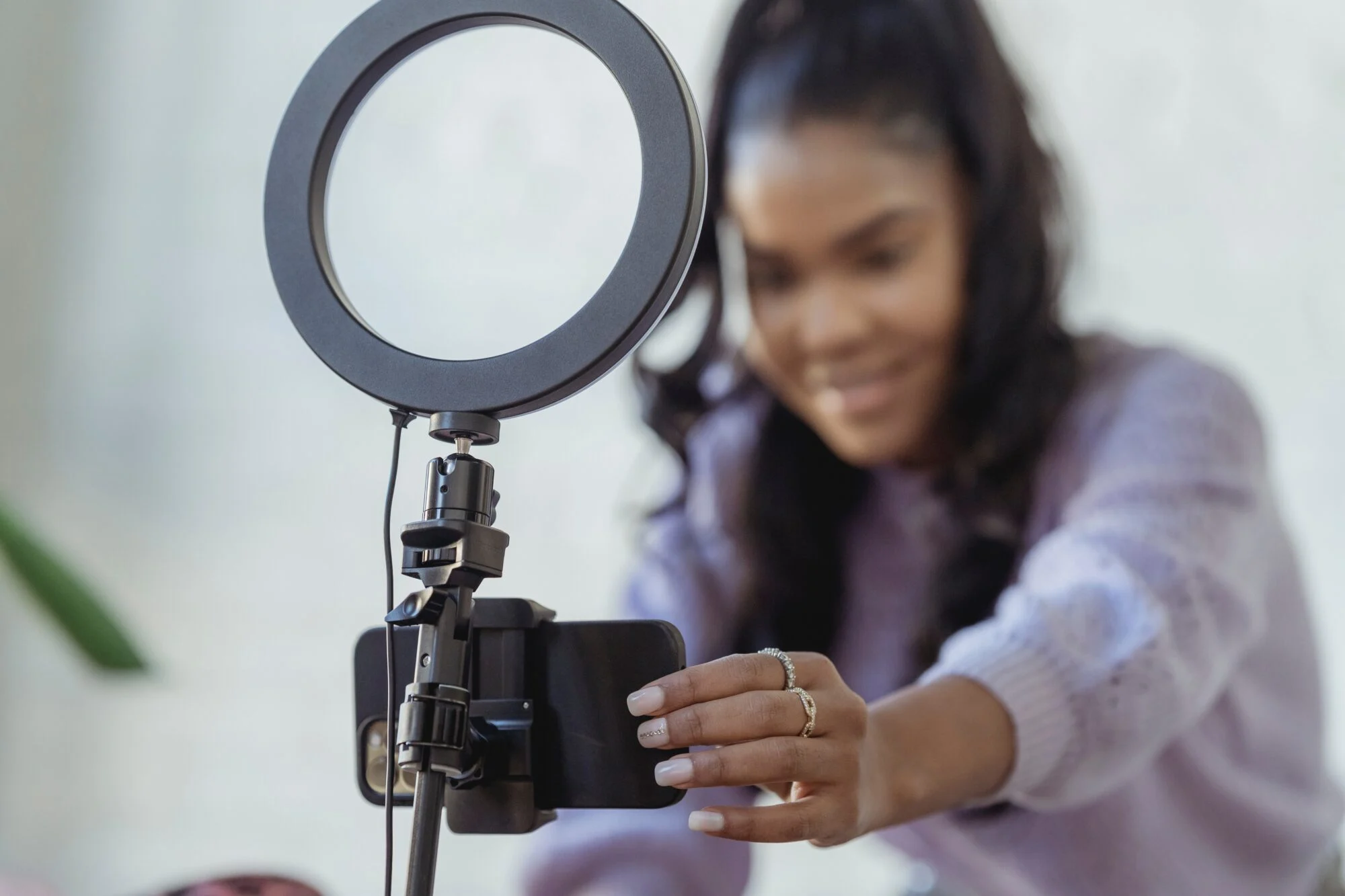 An influencer on their iPhone preparing to record a video to promote a product.