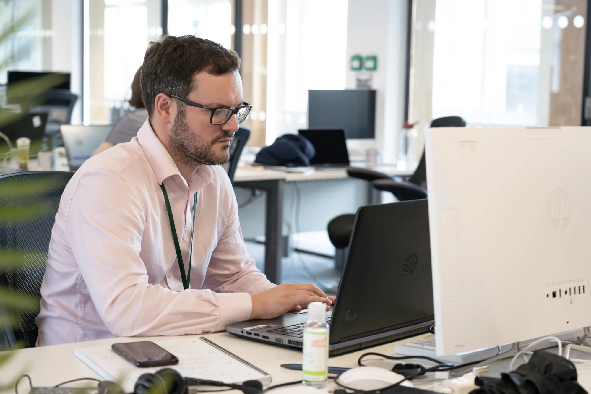 The Head of PPC, Edward Potter typing an email on his laptop explaining what is quality score in SEO. 