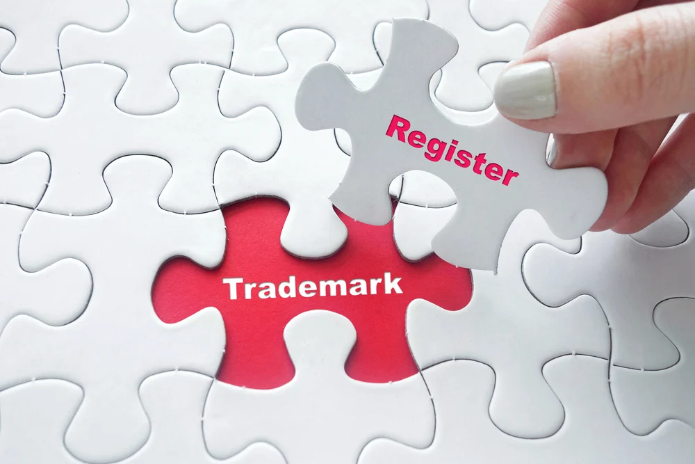 The final piece of a jigsaw being fitted with the words "registered trademark".