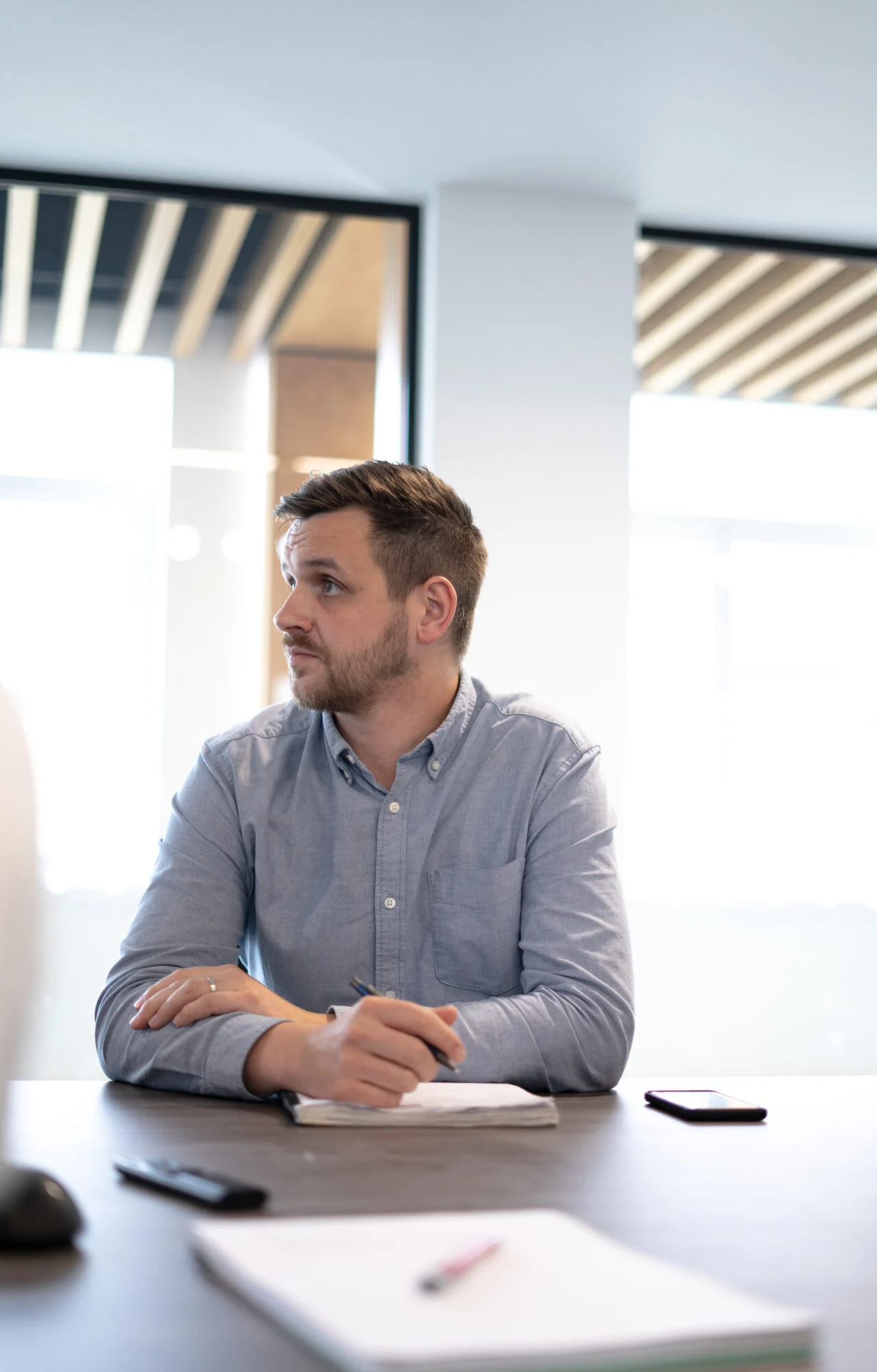 The Head of Creative at Castle, Pete Richardson sitting in a board meeting explaining how to trademark a logo in the UK. 