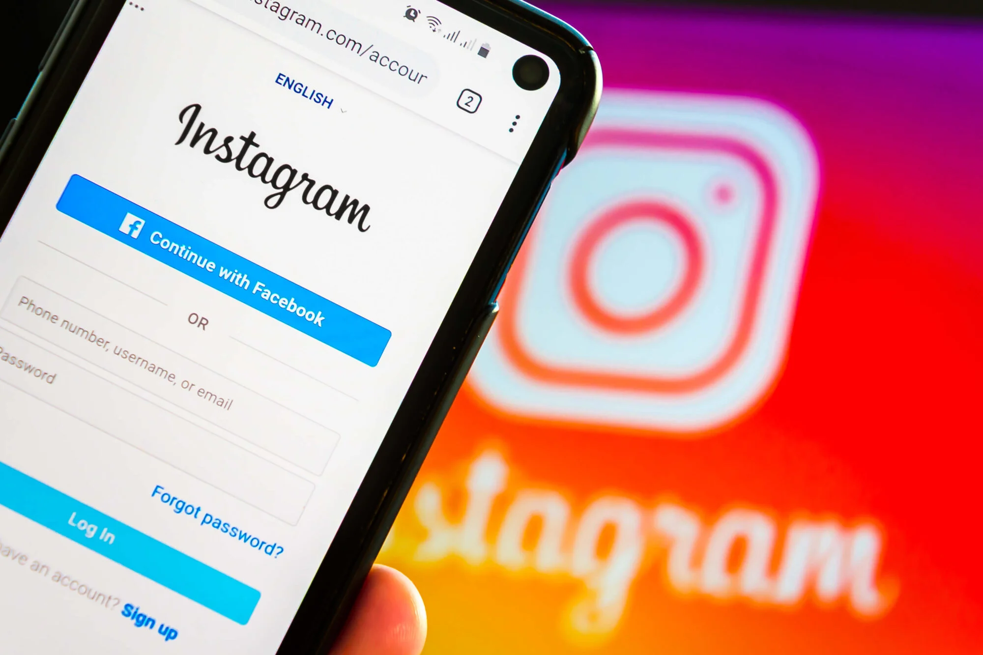 The Instagram website displayed on a computer and iPhone, showing people how to add multiple images to an instagram story.