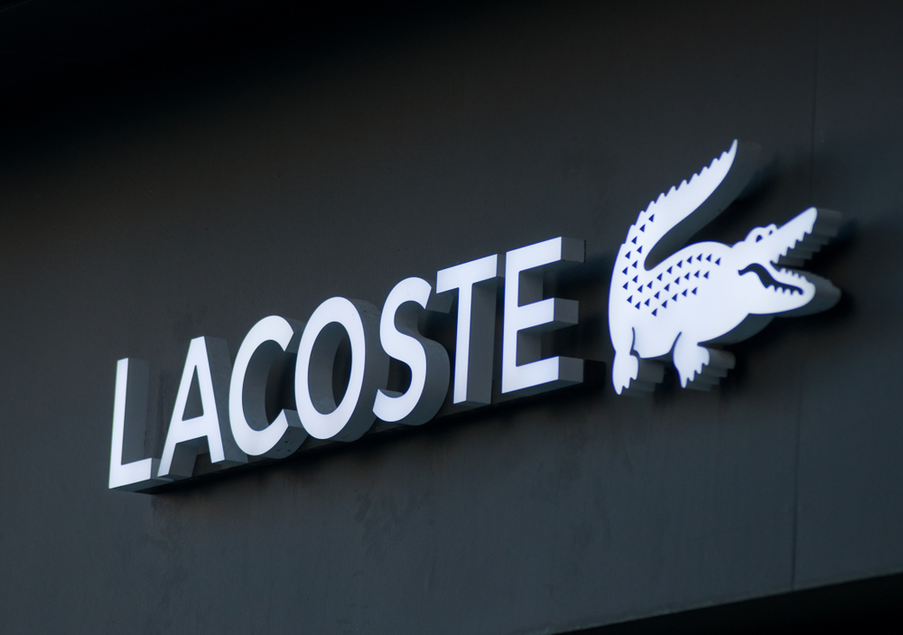 Photo of white lacoste logo against a black background