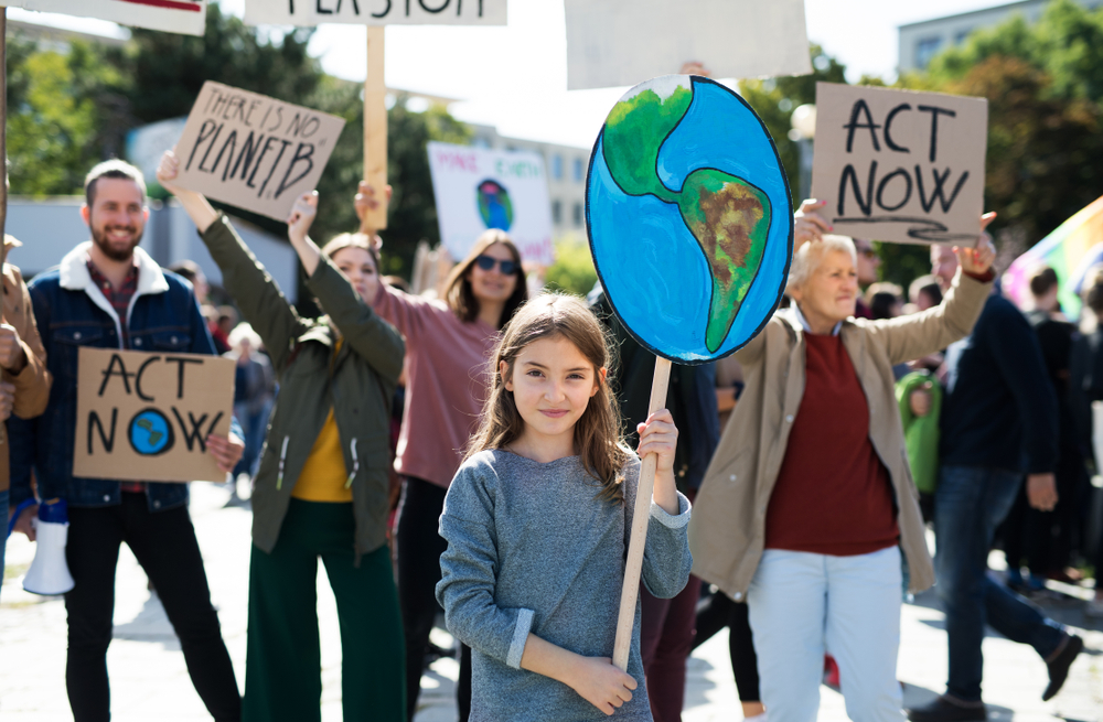 Groups of protestors with climate change protest signs