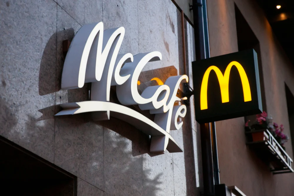 The outside of a McDonald's restaurant showing the McCafe sign to demonstrate what is product branding and how effective it can be,