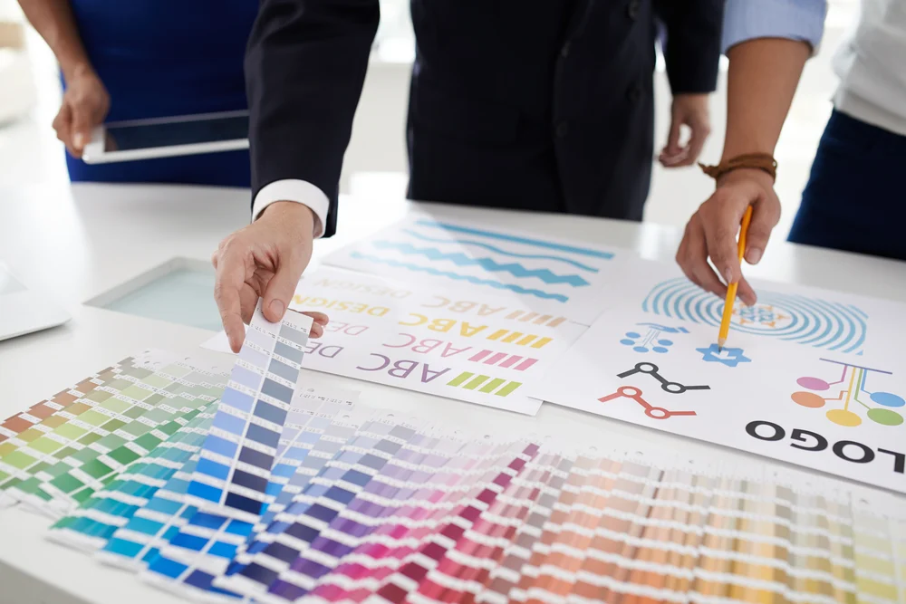Two graphic designers conducting research into what factors should go into their brand guidelines.