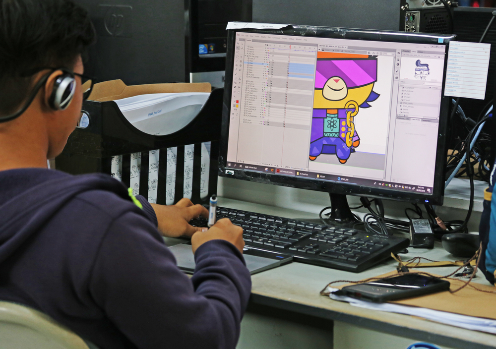 An animator working on the Adobe suite, designing an animation to show how has animation grown over the years in advertising.
