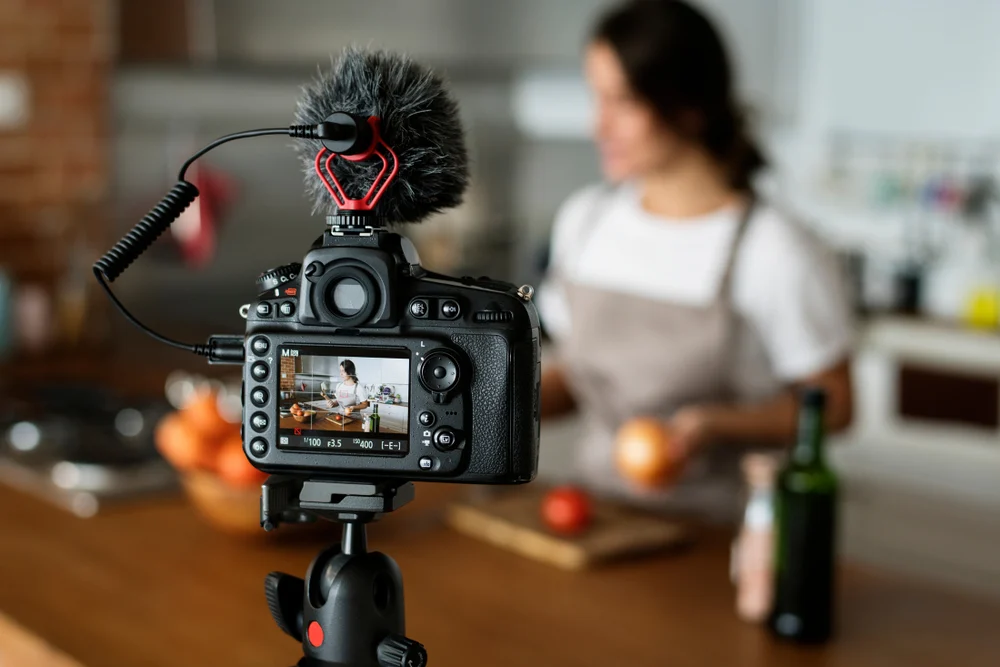 A female vlogger recording a video for her audience to demonstrate the effect of affiliate marketing.