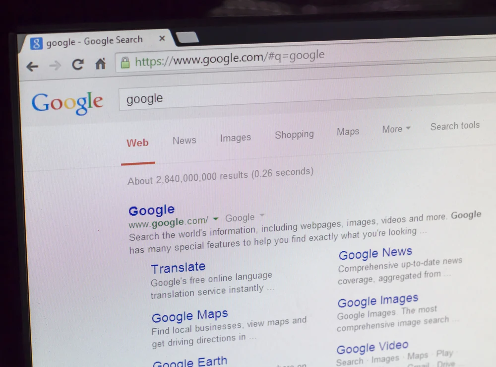 A laptop with the Google search engine open to show what a meta description is to explain what duplicate meta descriptions are.