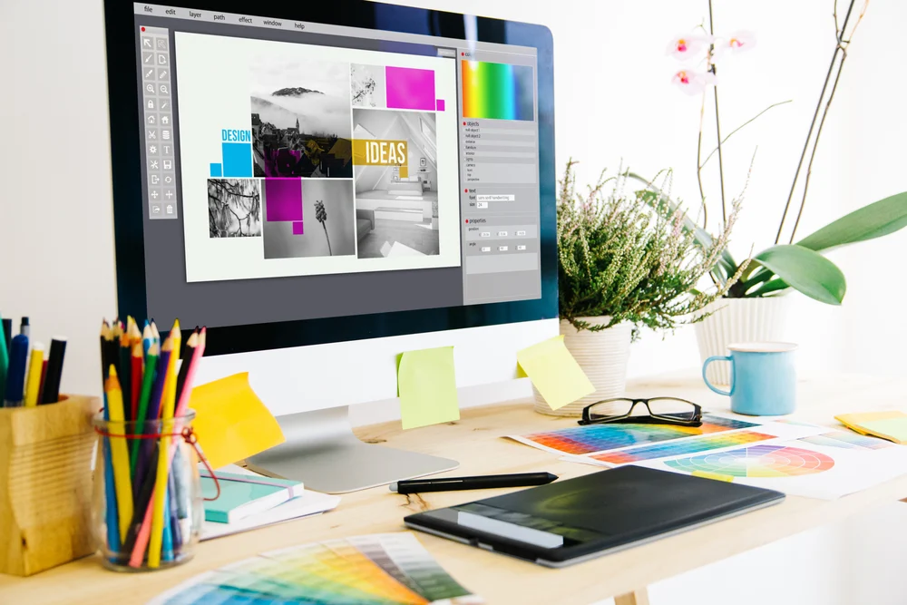 A Mac computer with Photoshop open gathering designs to build a design portfolio. 