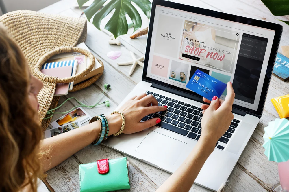 A person holding their credit card preparing to purchase a product of interest. This is to demonstrate what are the key success metrics for PPC. 