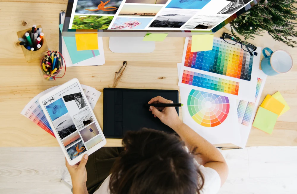 A designer working on their design portfolio before uploading them to Behance and Dribble. 