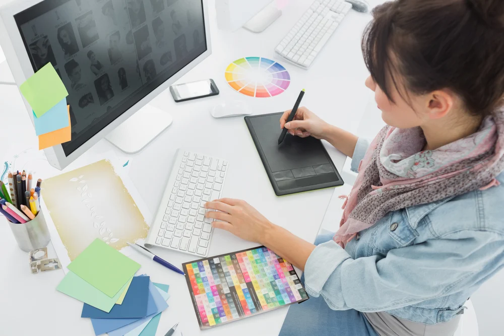 A graphic designer working on her portfolio after researching how to make a good design portfolio. 