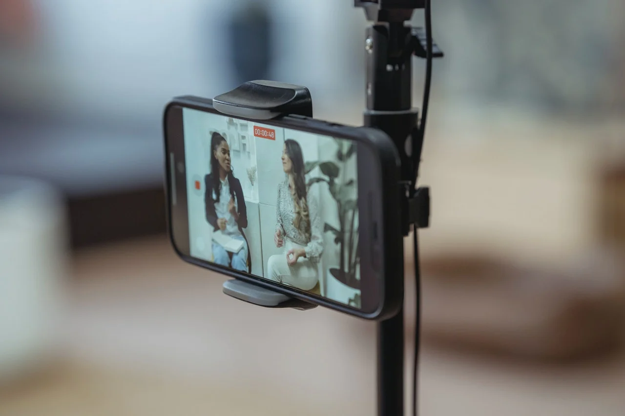 An influencer recording a video explaining with her guest how many followers do you need to be an influencer.