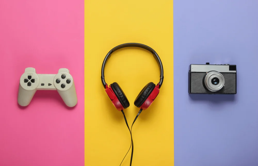 Pop culture attributes in the form of a video game controller, a pair of headphones and a camera to showcase the importance of pop culture in marketing.