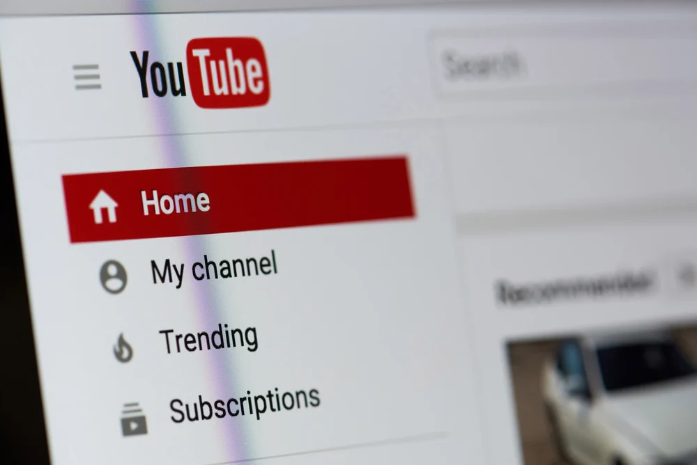 A YouTuber logging into his YouTube page, showing a screenshot of the YouTube homepage. 