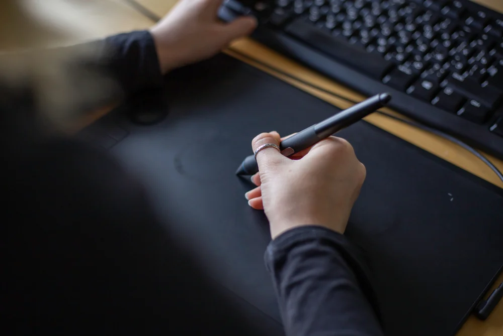 An animator working on their computer to demonstrate how is animation used in advertising.