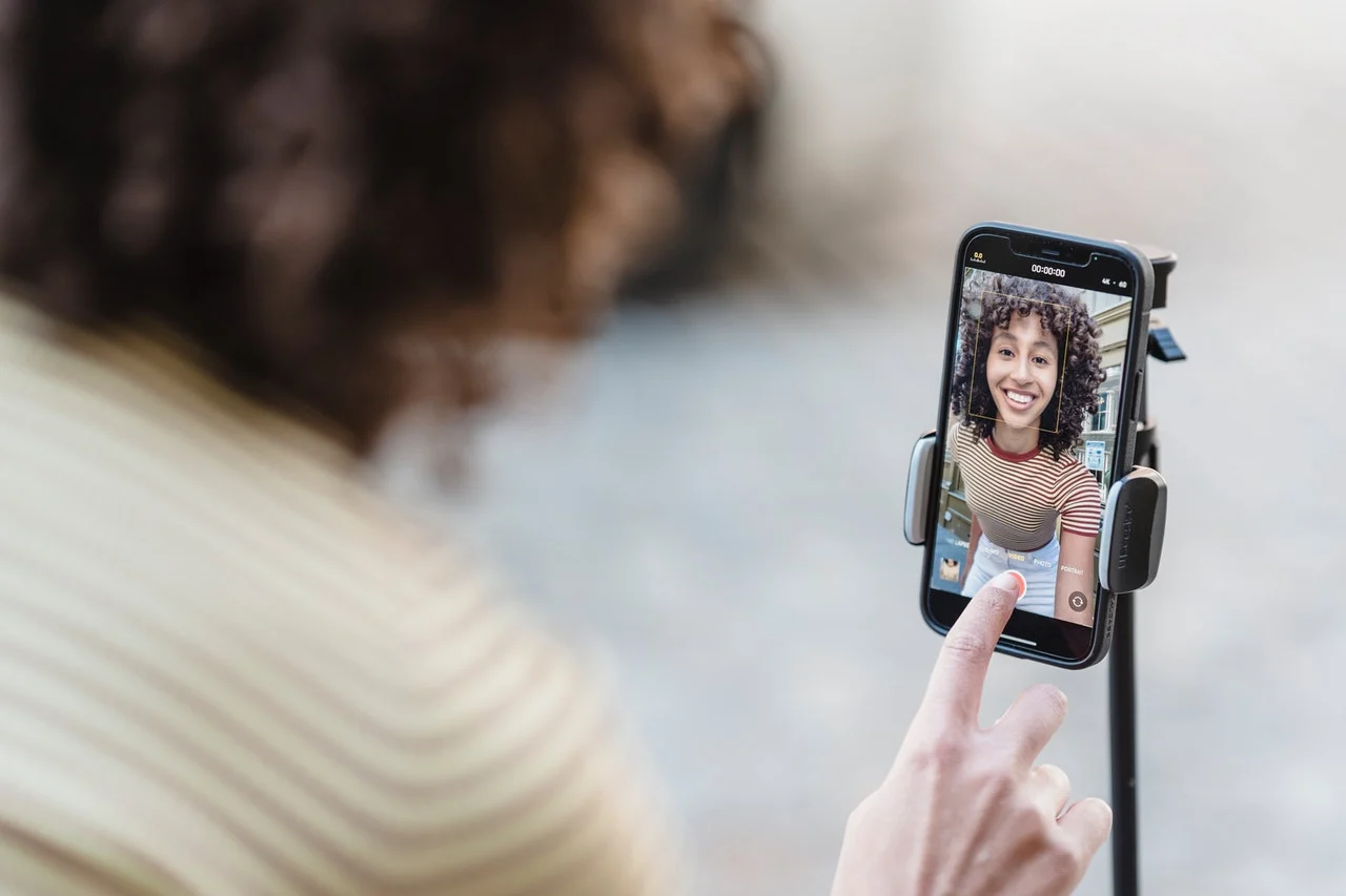An influencer recording a video on her phone explaining how many followers do you need to be an influencer.