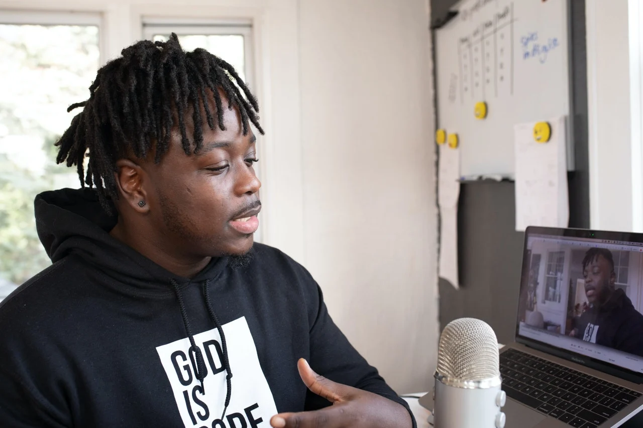 An influencer wearing a jumper recording a video to explain how many followers do you need to be an influencer