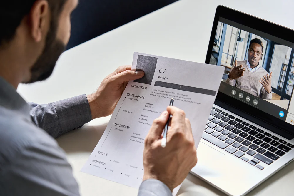 A person reviewing an interviewees CV during an interview. 