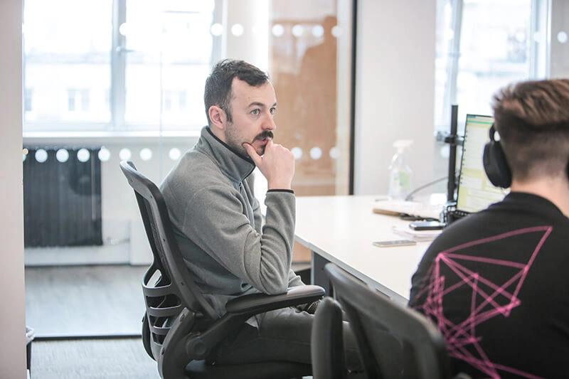 Castle Int. consultant deep in thought during a discussion at his desk