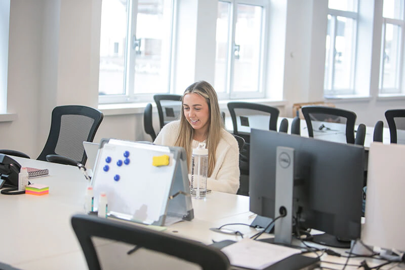 Castle Int. consultant working at her desk in the bright Liverpool office