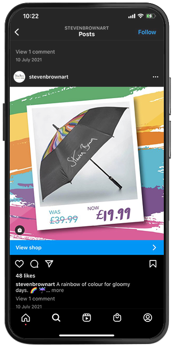 Smartphone showing a Steven Brown Art Instagram post promoting a rainbow umbrella offer