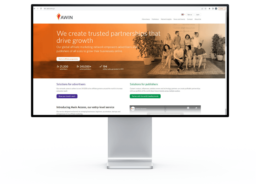 Desktop monitor displaying the Awin affiliate network website homepage