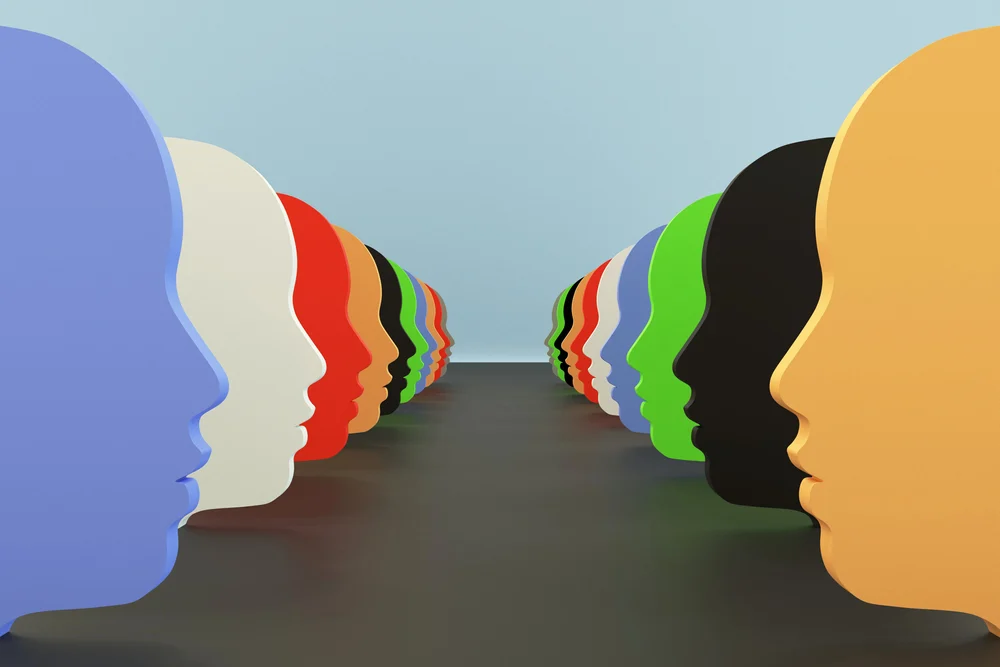 A row of abstract faces in side profile in different colours.