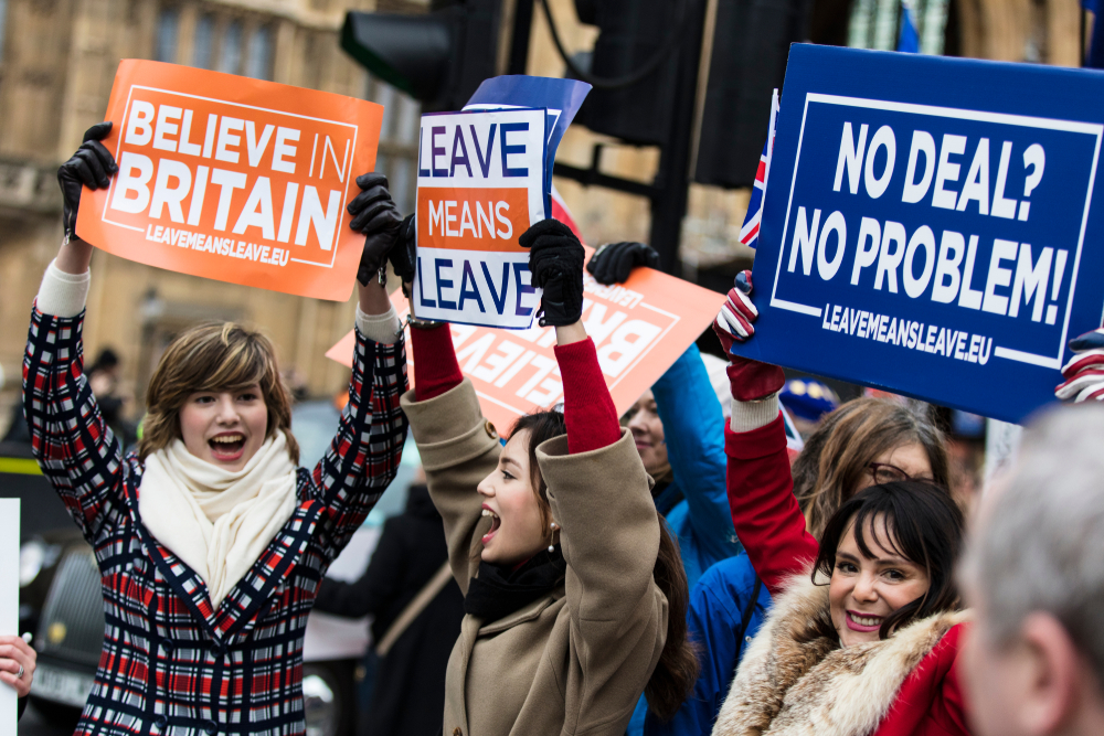 Brexit supporters in London holding banners campaigning to leave the EU.