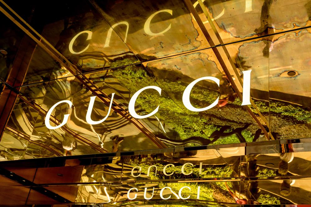 Gucci logo on a reflective gold shopfront