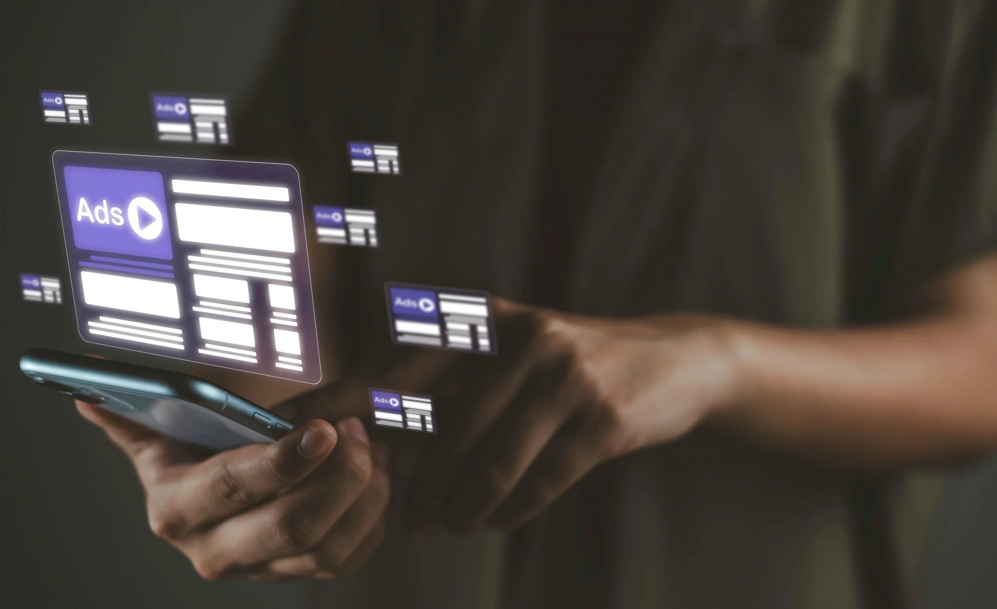 A picture of several ads floating above a smartphone someone is holding 