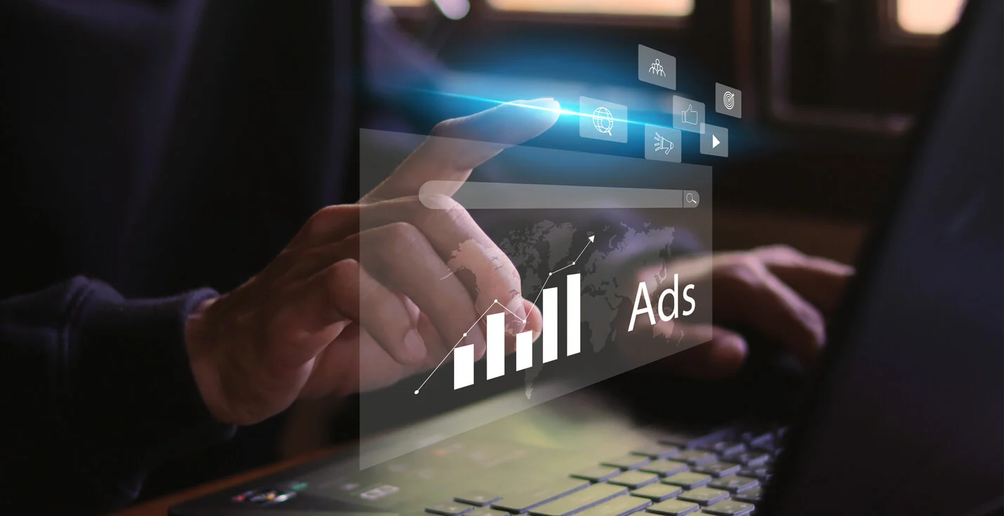 A persons hand touching a hovering graphic that says ads with a bar chart next to it.