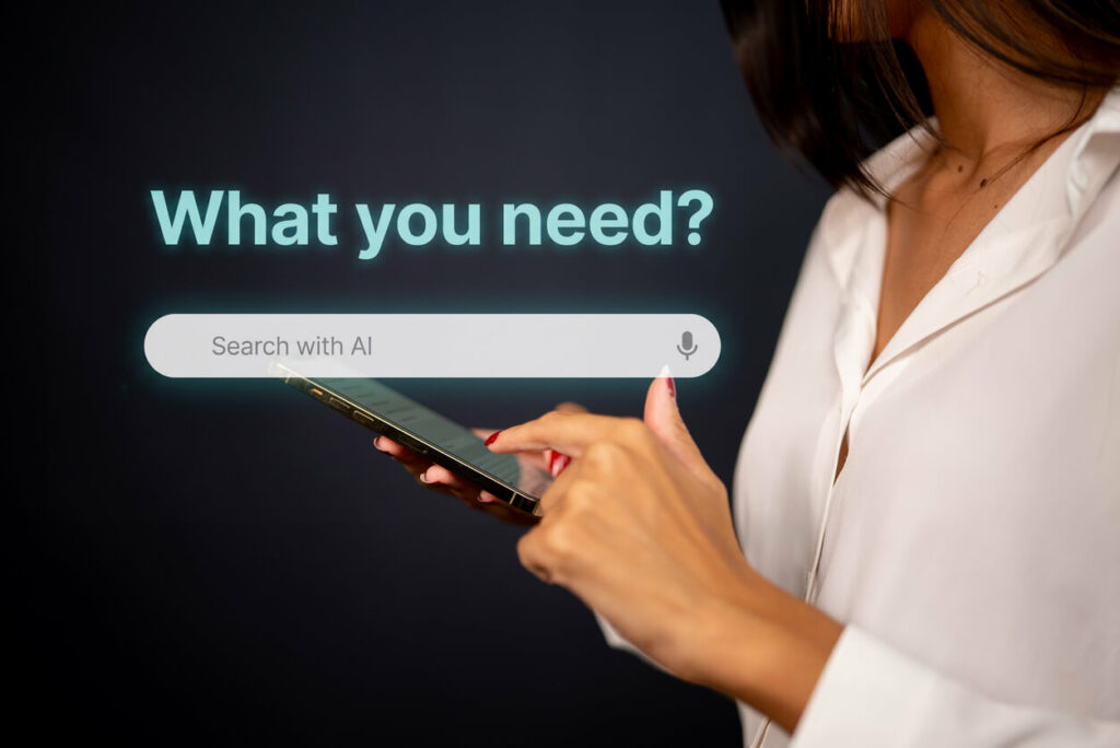 Woman scrolling on her smartphone in the background with an Ai search bar in the foreground with the title 'What do you need?' in blue over it