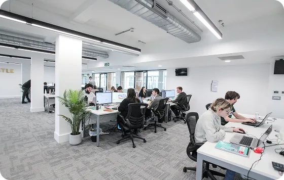 Castle team members working together in the Liverpool office