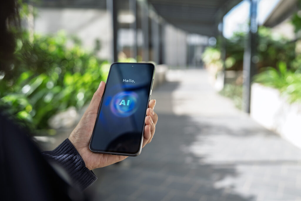 User accessing an AI assistant on a smartphone while outdoors, demonstrating mobile artificial intelligence technology for communication and productivity.